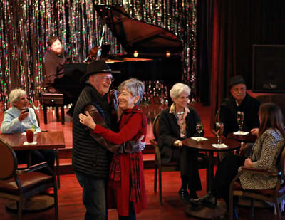 Residents enjoying a music night with dancing.