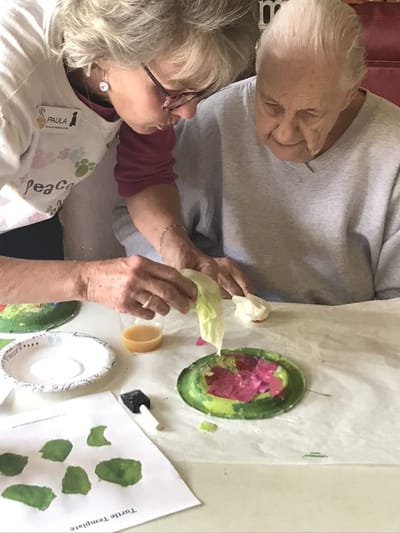 Resident crafting with staff assistance