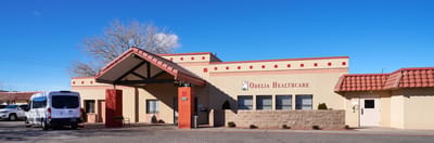 Front entrance of a healthcare facility with transportation van