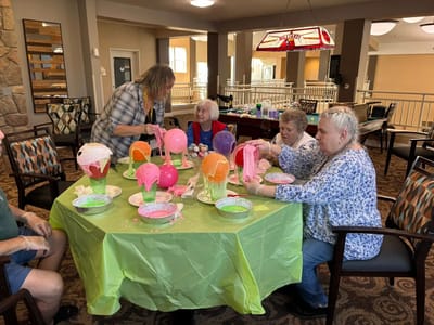 Residents engaged in a crafting activity at a table
