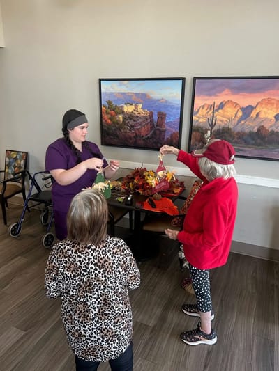 Residents and staff engaging in a seasonal crafting activity