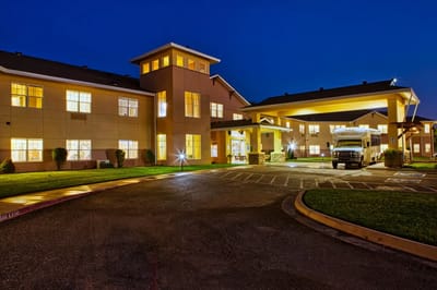 Exterior view of Wheatfields Senior Living Community at night