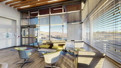 Bright common area with seating and large windows