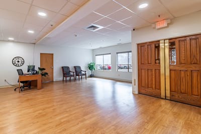 Bright, spacious interior lobby area with wooden doors