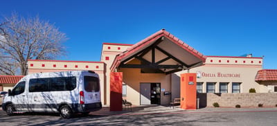 Exterior view of facility entrance with transport van