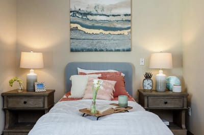 Cozy resident bedroom with lamps and artwork