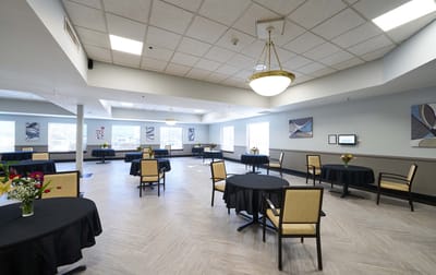 Bright dining area with round tables and flower arrangements