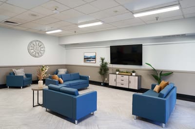 Bright common area with blue sofas and modern decor