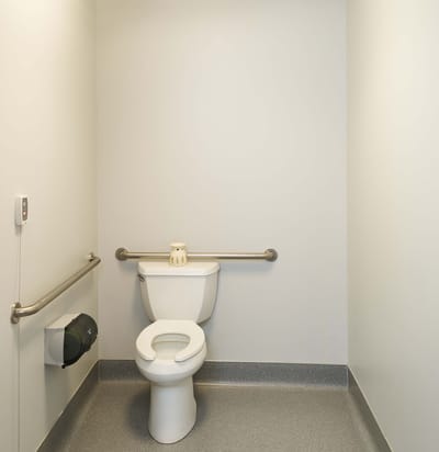 Clean bathroom stall with grab bars