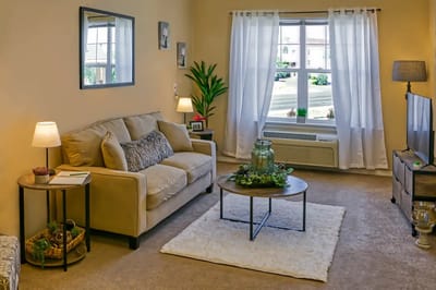 Bright and cozy living room in a resident suite