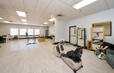 Rehabilitation gym with exercise equipment and therapy areas
