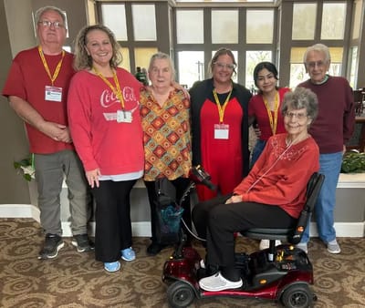 Residents and staff posing together in a common area