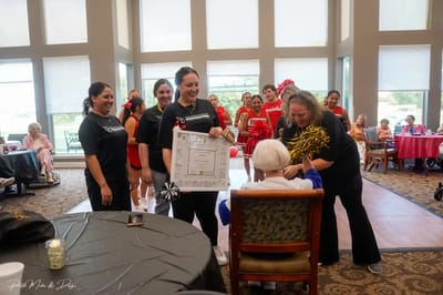 Residents and staff celebrating in a common area