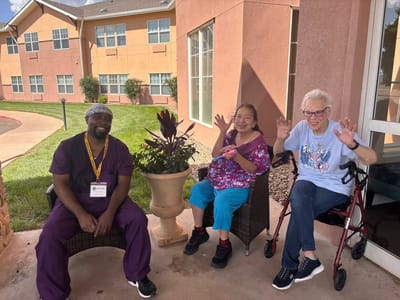 Residents and staff enjoying an outdoor space together