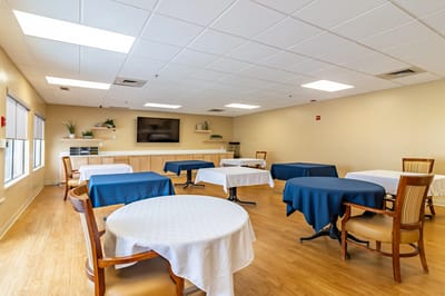 Dining area with tables set for residents