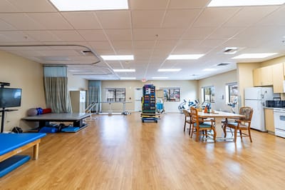 Rehabilitation room with exercise equipment and tables