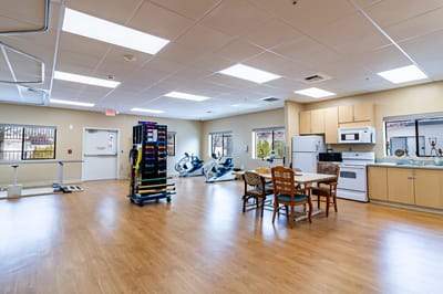 Interior of a rehabilitation area with equipment and dining space