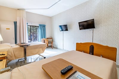 Resident room with two beds and a window