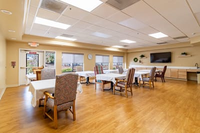 Bright common dining area with tables and chairs