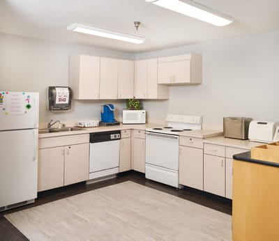 Bright kitchen area with appliances and cabinets