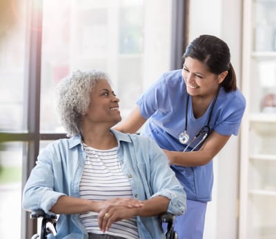 Caregiver assisting a resident in a cozy room
