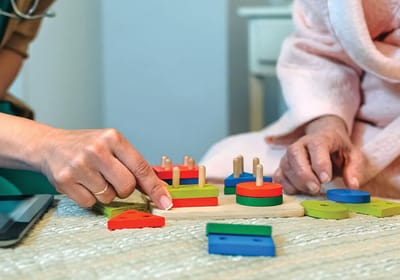Residents engaging in a cognitive activity with staff assistance