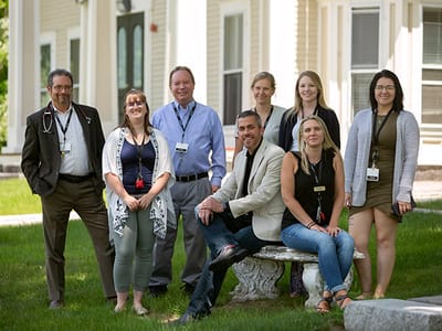 Group of staff members posing outside the facility
