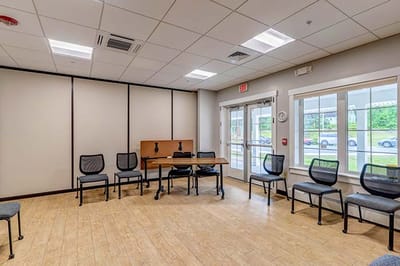 Empty activity room with chairs and table