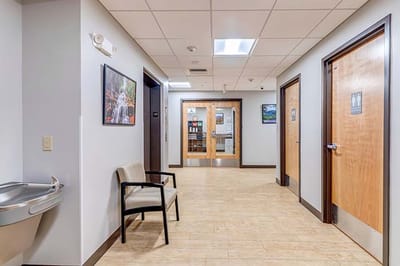 Interior hallway of a senior living facility with seating