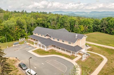 Aerial view of a senior living facility surrounded by greenery