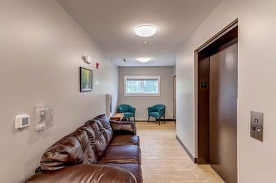 Interior common area with seating and elevator