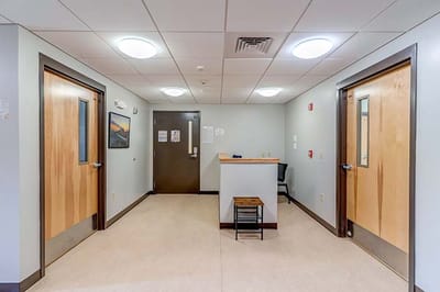 Interior hallway with resident rooms and a reception area