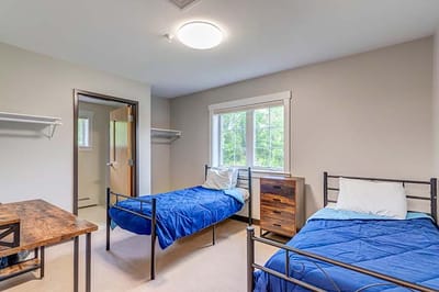 Private resident room with two beds and a window