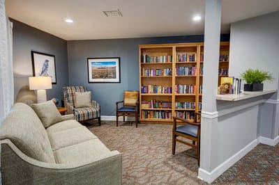 Cozy common area with seating and bookshelves