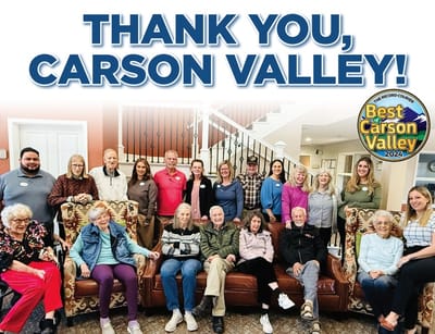Residents and staff gathered for a group photo in a common area