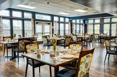Dining area set for meals with floral decor