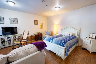 Cozy resident room with bed and seating area
