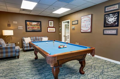 Interior billiard room with pool table and seating