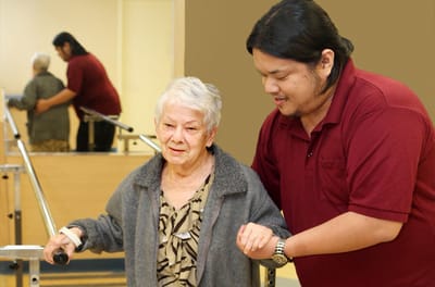 Staff assisting a resident during therapy