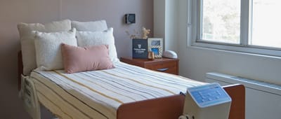 Cozy resident room with bed and natural light