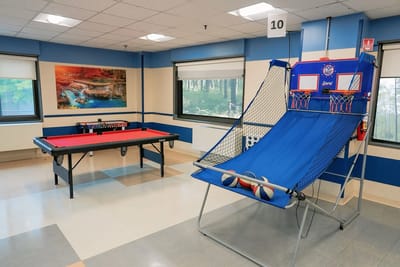 Activity room with pool table and basketball hoop