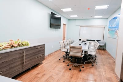 Bright, modern conference room with meeting table and chairs