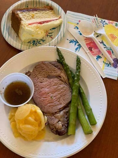 Dinner plate with roast beef, vegetables, and dessert