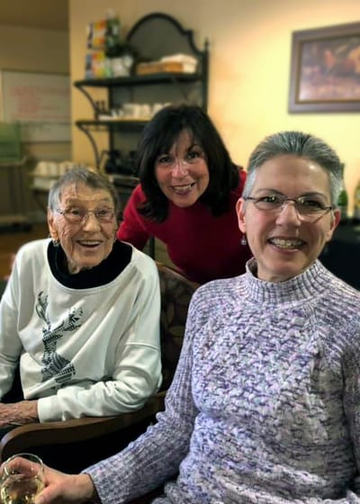 Three residents enjoying time together in a cozy common area
