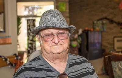 A resident wearing a hat in a bright common area
