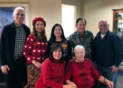 Residents and staff posing together in a common area