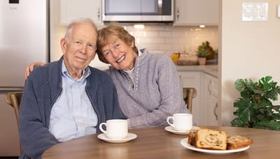 Happy couple enjoying coffee in a cozy kitchen