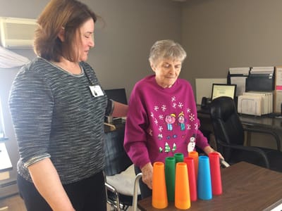 Staff assisting a resident with an activity