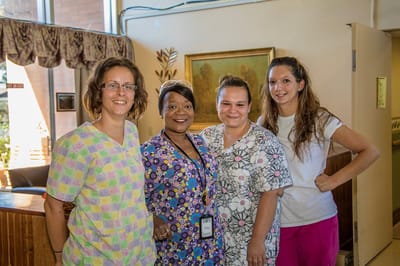 Staff members posing together in a common area