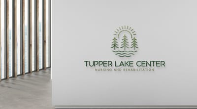 Facility logo on a light wall near windows